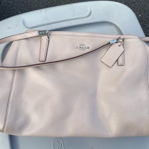 Coach light stone colored over the shoulder purse. Silver accents.